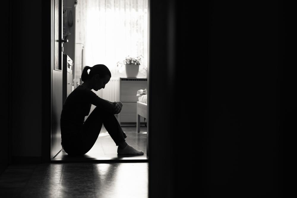 Sad,Young,Woman,Sitting,On,Floor,At,Home,In,A